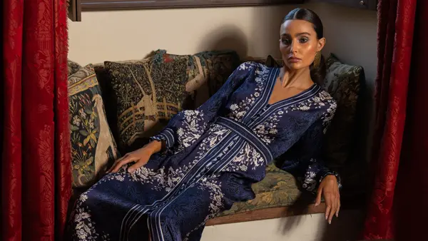 Dame sitter henslengt i en sofa