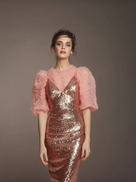 Fashionable woman in pink sequin dress and ruffle top