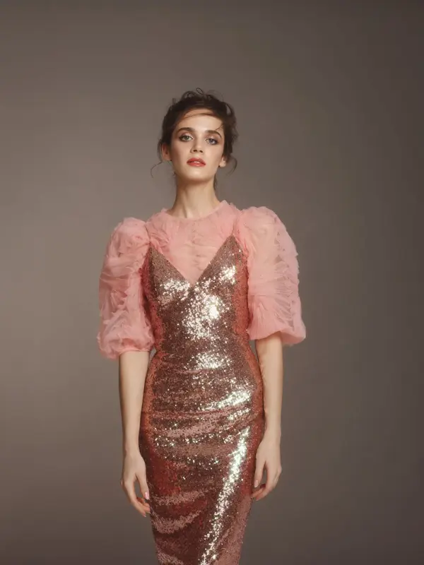 Fashionable woman in pink sequin dress and ruffle top