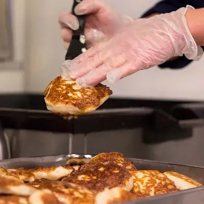 Person plukker fiskekaker fra form