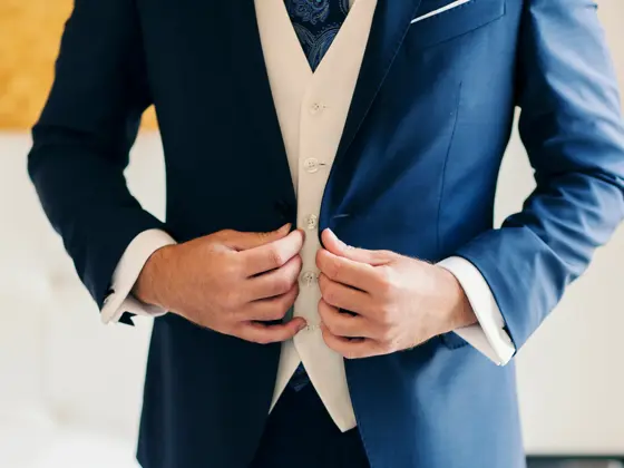 Businessman or groom getting dressed
