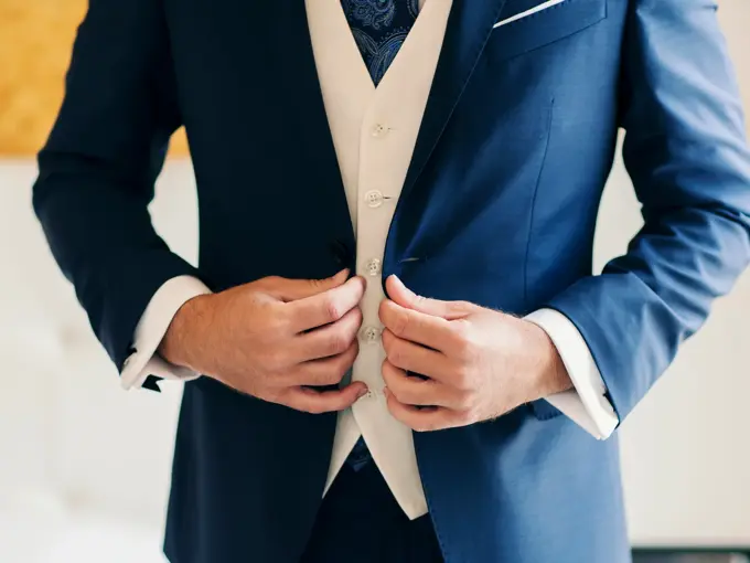 Businessman or groom getting dressed