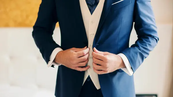 Businessman or groom getting dressed