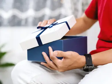 A Person Opening A Gift Box