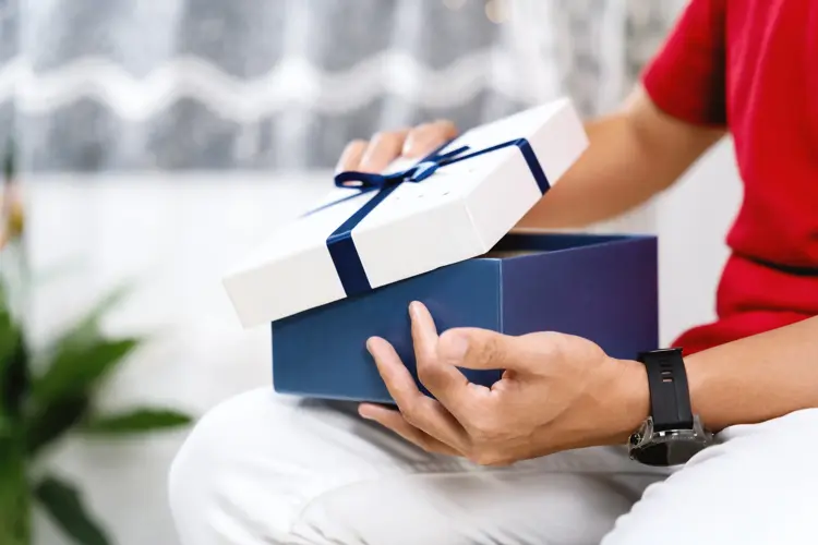 A Person Opening A Gift Box