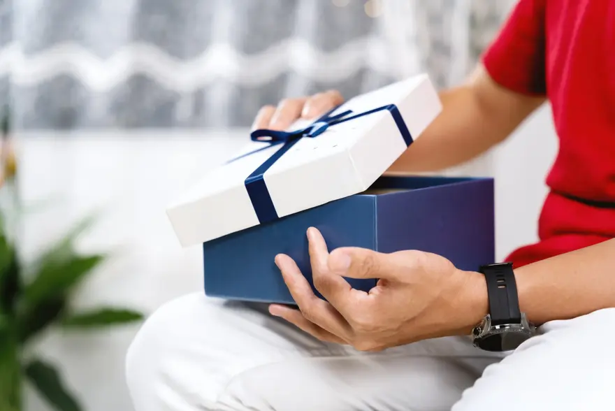 A Person Opening A Gift Box