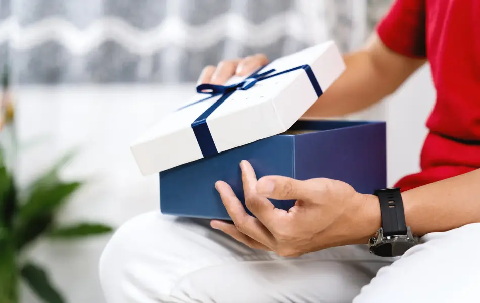A Person Opening A Gift Box