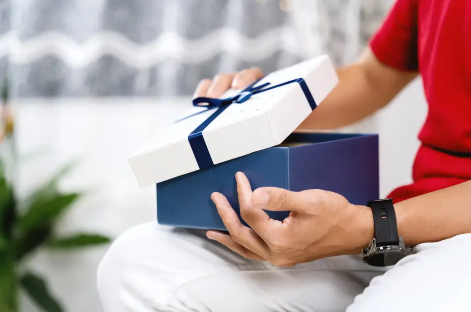 A Person Opening A Gift Box