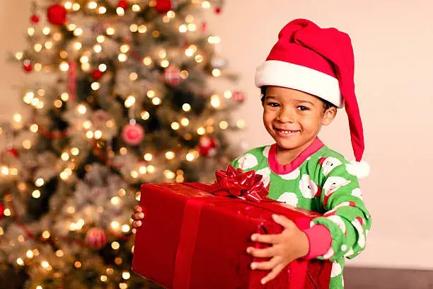 A young boy is excited for Christmas morning and the opening of presents.