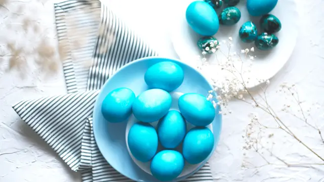 Bright easter composition with colored blue eggs. Easter flat lay.