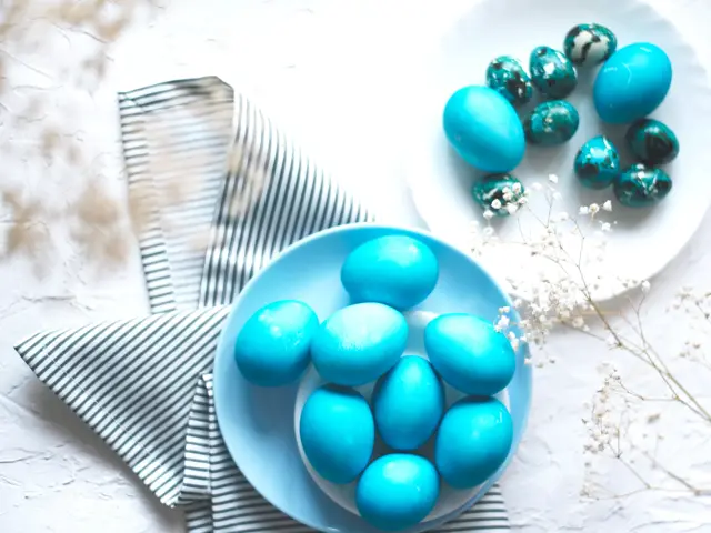Bright easter composition with colored blue eggs. Easter flat lay.