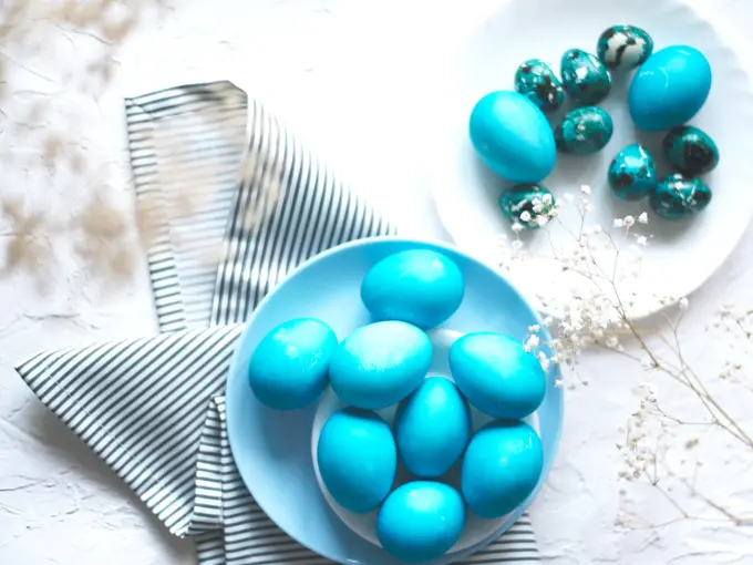 Bright easter composition with colored blue eggs. Easter flat lay.