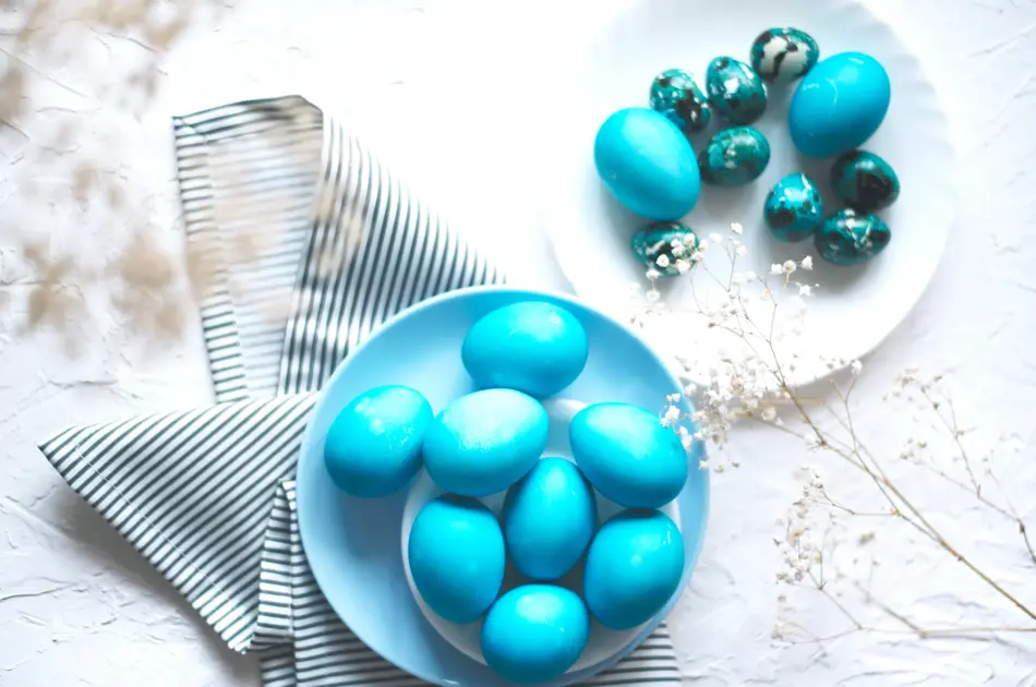 Bright easter composition with colored blue eggs. Easter flat lay.
