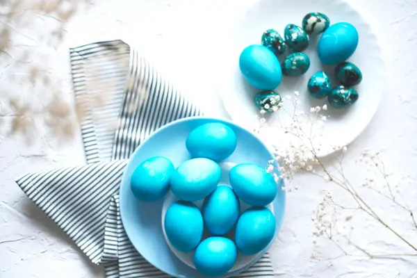 Bright easter composition with colored blue eggs. Easter flat lay.