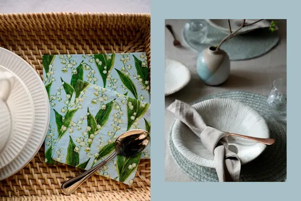 Kurv med hvitt servise og servietter. Bord lysegrå duk, servise, pynt og tøyserviett.