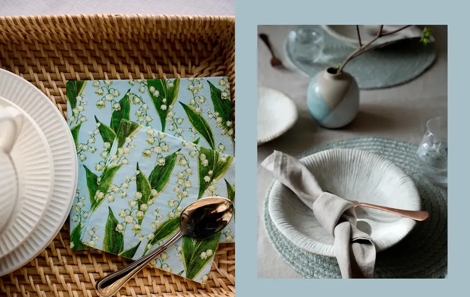 Kurv med hvitt servise og servietter. Bord lysegrå duk, servise, pynt og tøyserviett.