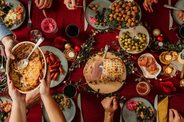 Typical swedish scandinavian christmas smörgåsbord buffet food Photo taken from above overhead table top shot Photot of typical smorgasbord with breaded ham, meatballs, sausauge,noisette, pickled herring and side dishes Julbord med griljerad skinka sill och lax