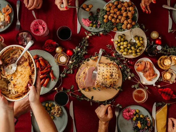 Typical swedish scandinavian christmas smörgåsbord buffet food Photo taken from above overhead table top shot Photot of typical smorgasbord with breaded ham, meatballs, sausauge,noisette, pickled herring and side dishes Julbord med griljerad skinka sill och lax
