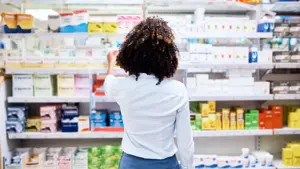 Rearview shot of a young woman looking at products in a pharmacy