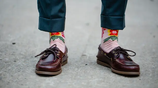 Close-up of the shoes and funny socks of a man