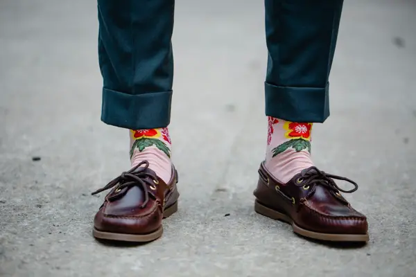 Close-up of the shoes and funny socks of a man