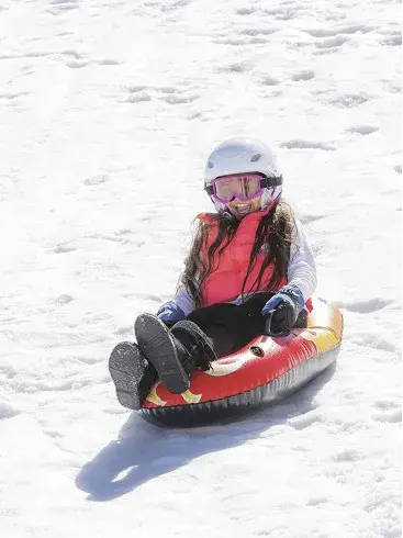 Jente på akebrett nedover bakken