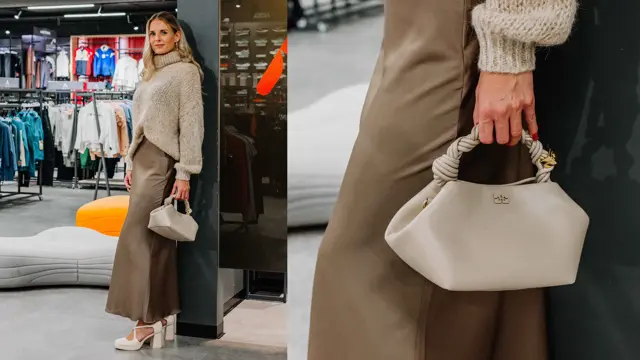 Dame med beige genser, brunt skjørt, beige veske og høye hæler