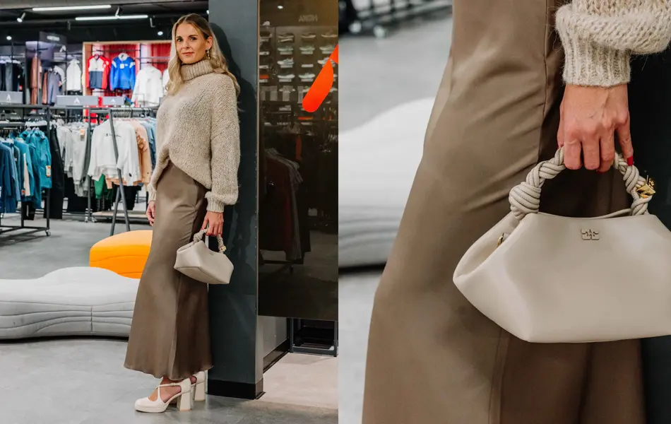 Dame med beige genser, brunt skjørt, beige veske og høye hæler