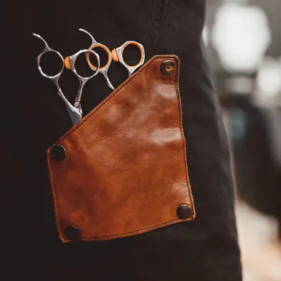 banner Barber shop. Close-up of scissors for hair cutting, in background chair. copyspace