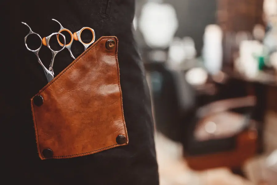 banner Barber shop. Close-up of scissors for hair cutting, in background chair. copyspace