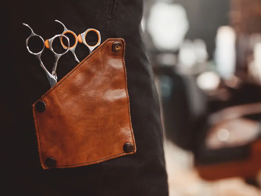 banner Barber shop. Close-up of scissors for hair cutting, in background chair. copyspace