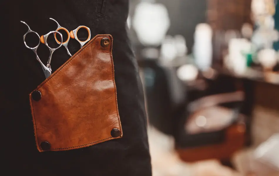 banner Barber shop. Close-up of scissors for hair cutting, in background chair. copyspace