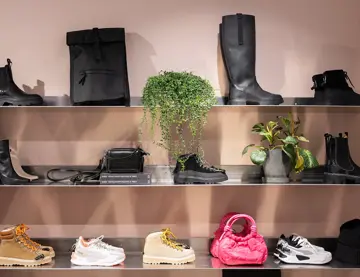 Hyller med sko, vesker og bager i en klesbutikk