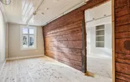 Et kontorlokale i Svensgården på Bryggen i Bergen. Historiske tømmervegger er bevart som en integrert del av lokalene og skaper en arbeidsplass med unik identitet.