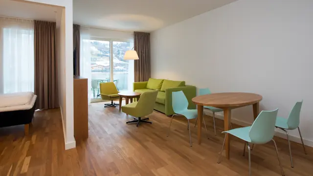 Dobbeltseng, sofa og bord med flere sitteplasser på Business room  på Thon Hotel Sandven