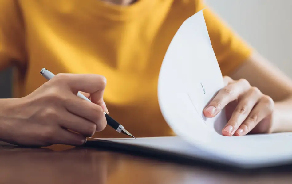 Woman signing document and hand holding pen putting signature at paper, order to authorize their rights.