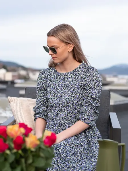 Jente i blomsterkjole og solbriller