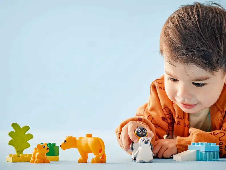 En liten gutt som leker med Lego Duplo.