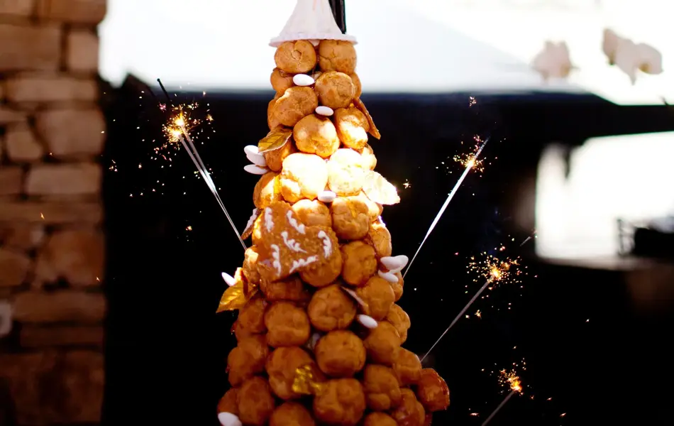croquembouche profiterole wedding cake tower with sparklers and bride and groom cake topper
