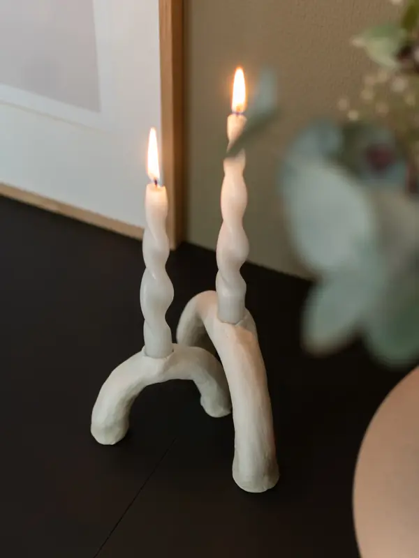 Hvite lysestaker med brennende lys