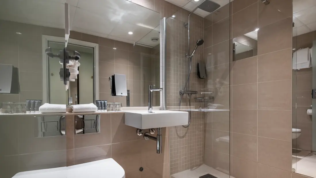 Bad med toalett, servant, stort speil, dusj med glassdør