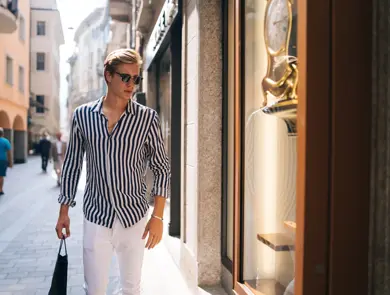 He looks into a store window