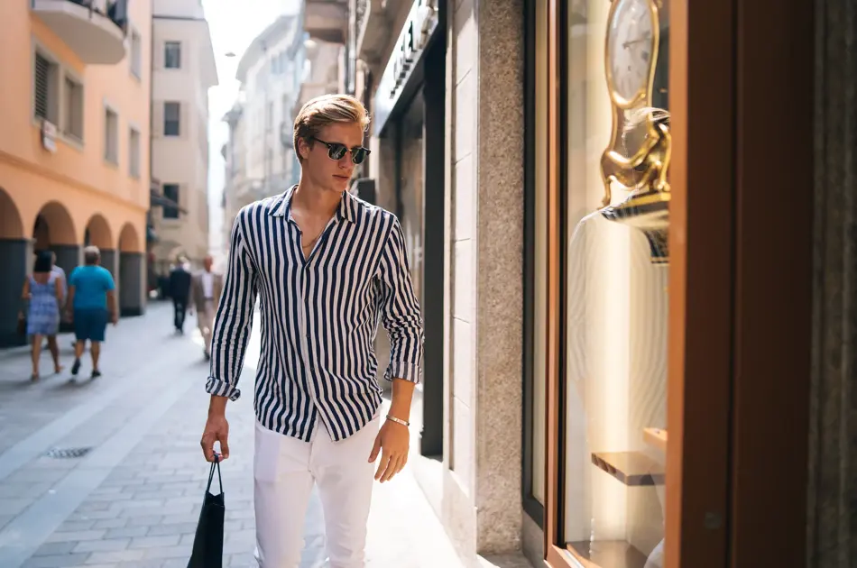 He looks into a store window