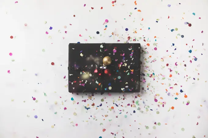 Black wrapped Christmas gift box on white background