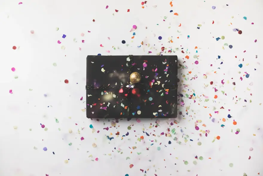 Black wrapped Christmas gift box on white background