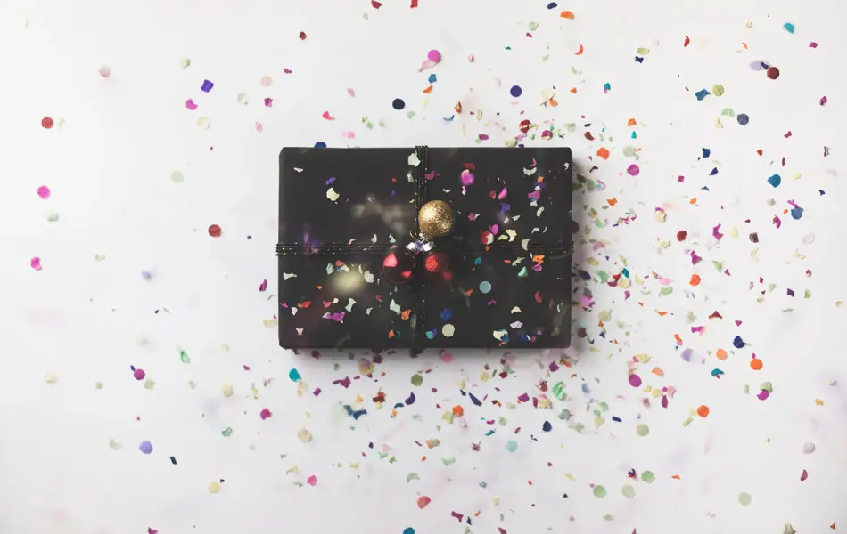 Black wrapped Christmas gift box on white background