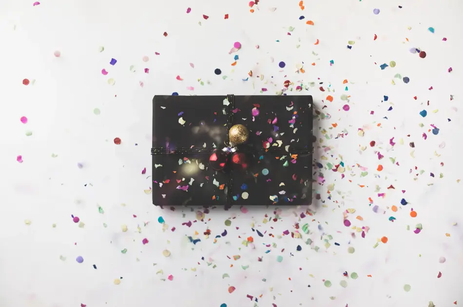 Black wrapped Christmas gift box on white background