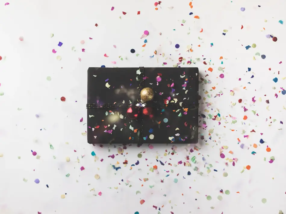 Black wrapped Christmas gift box on white background