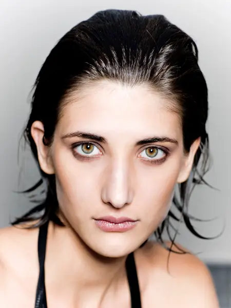 beauty portrait of young woman with beautiful green-blue-brown eyes.