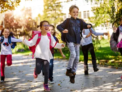 School kids running in schoolyard